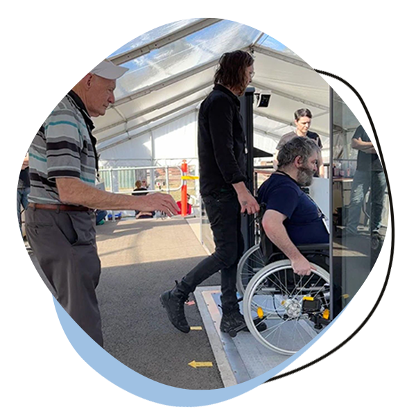 Man in wheelchair getting onto a train